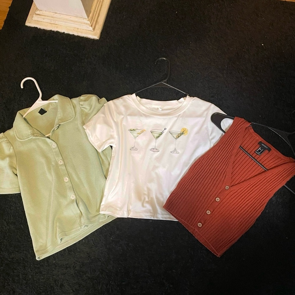 Green Button-Up Shirt, White Graphic Tee, and Rust Sleeveless Cardigan
